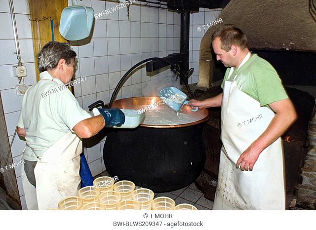 traditional cheese production: filling of shapes with a special cheese made of whey, called Ziegerkaese or Ricotta, Switzerland, Valais, Taeschalp, Zermatt