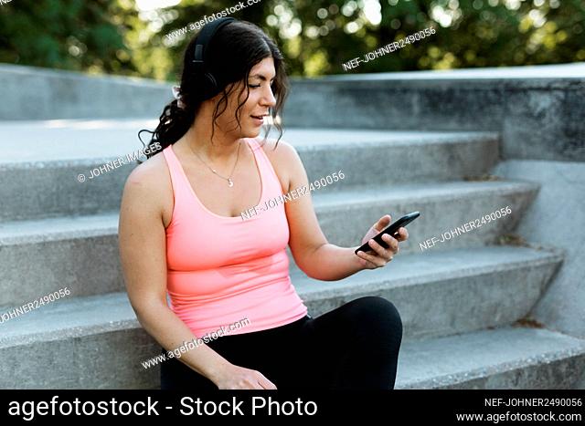 Woman on stairs using cell phone