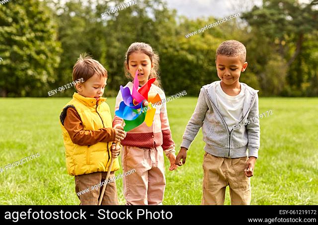 happy kids with pinwheel having fun at park