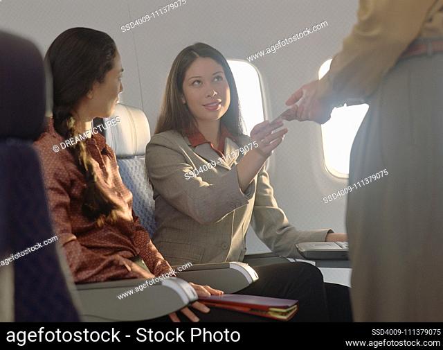 Young woman passing note to male passenger