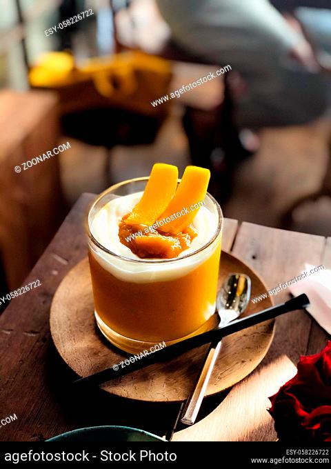 Mango smoothie with beautiful glass in modern cafe