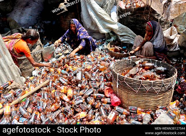 Locals are seen separating bottles of polyethylene terephthalate (PET) in a recycling factory on the outskirts of Dhaka. Recycling plastic bottles has become a...