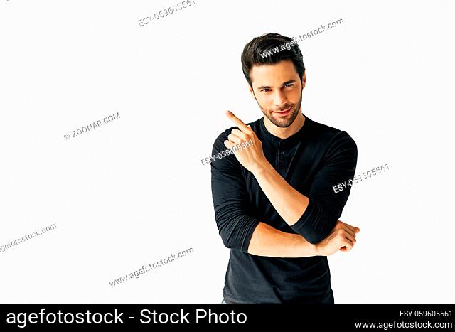 Handsome happy man pointing his finger showing empty copy space isolated on white background. Presenting product and advertising concept