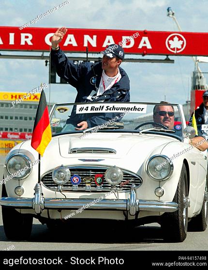 German Formula One driver Ralf Schumacher (C up) of BMW-Williams waves to spectators during the presentation of the drivers at Gilles-Villeneuve circuit in...