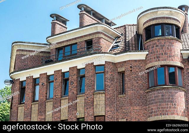 Anderlecht, Brussels - Belgium Brick stone shaped facade of a residential apartment in modernist style