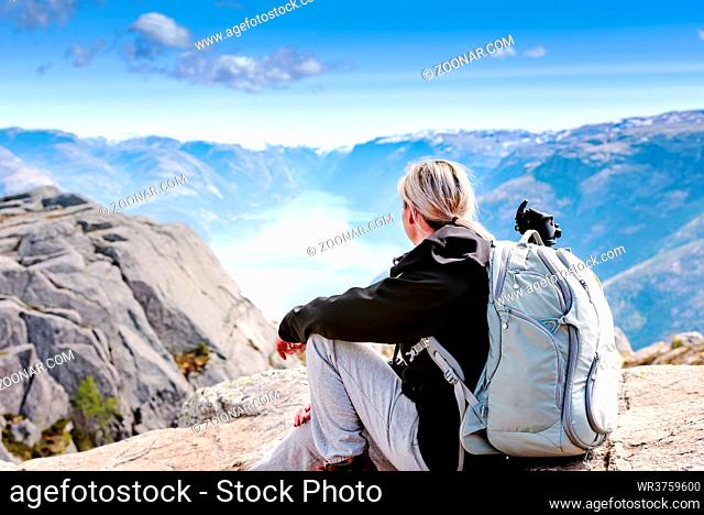 Picturesque Norway mountain landscape. Young girl enjoying the view near Lysefjord fjord, Norway