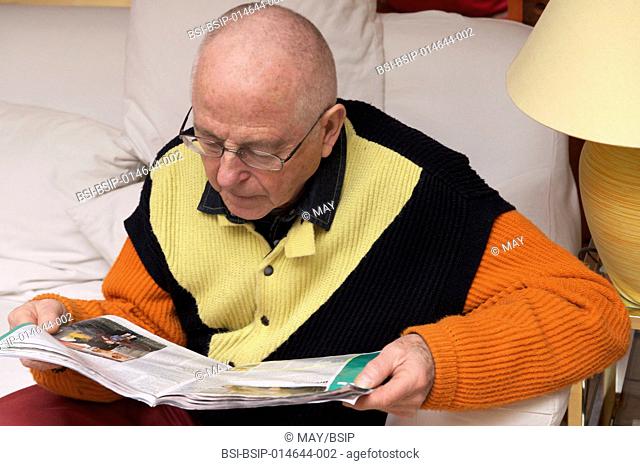 Senior man reading a magazine