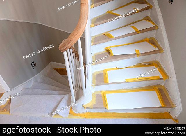 construction site, refurbishment and renovation of an apartment, covered steps in the stairwell of an old building