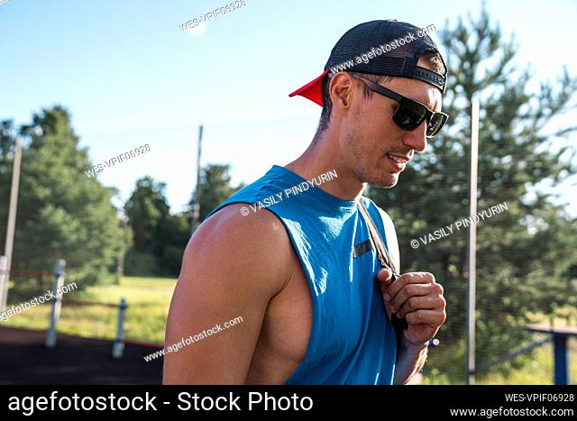 Sportsperson wearing cap and sunglasses on sunny day