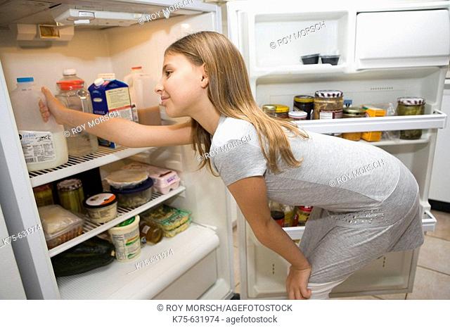 Girl looking in refrigerator