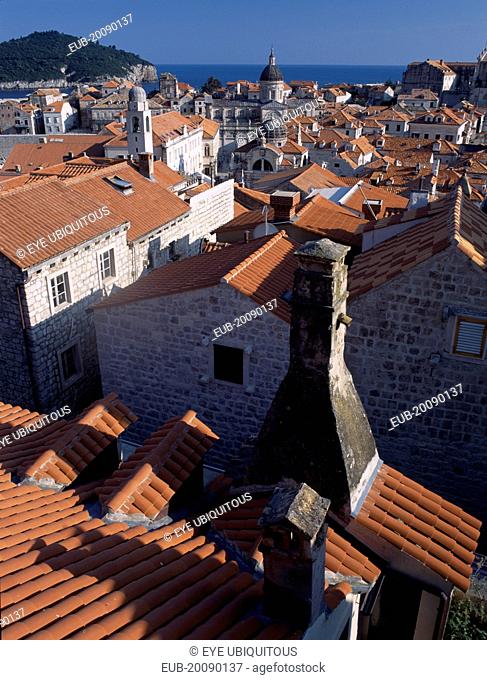 Elevated view over terracotta roof tops towards the Cathedral, St Blaise’s Church and clock tower in morning light