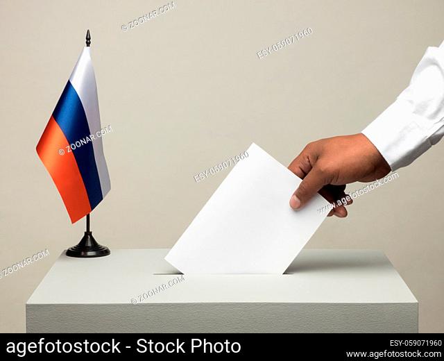Ballot box with national flag of Russia. Presidential election in 2018. hand throwing a ballot