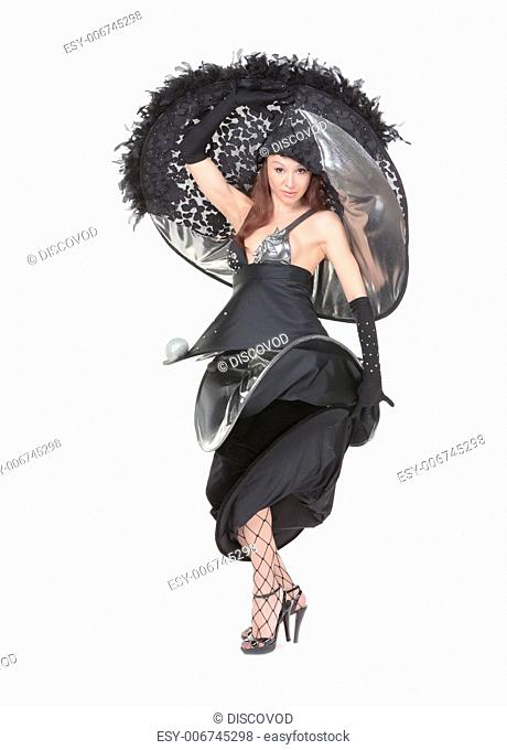 Beautiful young woman dressed in haute couture fashion wearing a modern stylish flamboyant evening outfit in black on a white background