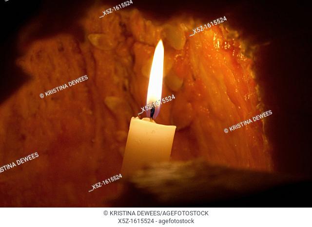 A lit candle inside a Jack O'lantern