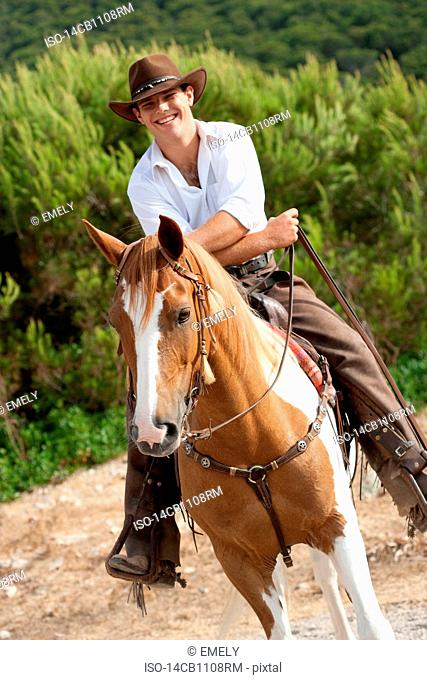man riding horse smiling