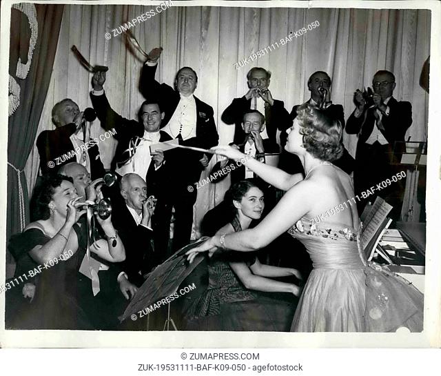 Nov. 11, 1953 - Anna Neagle Conducts. Photo shows Miss Anna Neagle, seen conducting a 'Toy Symphony' orchestra, including many well-known musicians