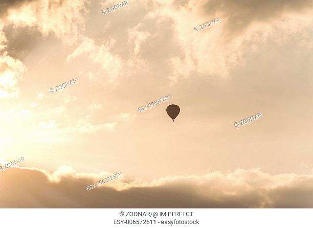 Hot air balloon silhouette at sunrise