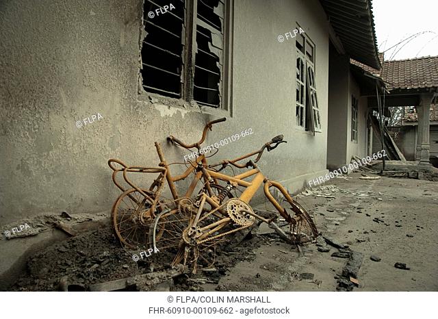 Ash, bikes and broken house windows, damaged from recent volcanic eruption, Kepuharjo, Mount Merapi, Central Java, Indonesia, november 2010