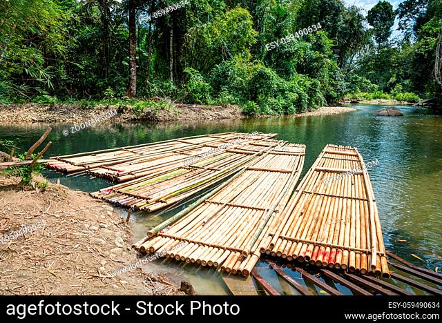 Bamboo rafts on green tropical river. Rafting is a popular tourist attraction in Thailand