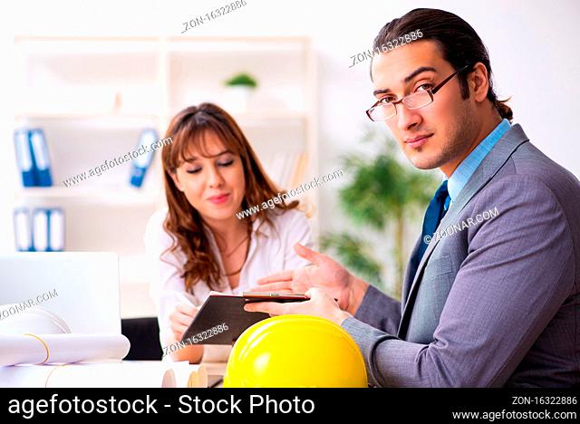 Businessman and female architect discussing new project
