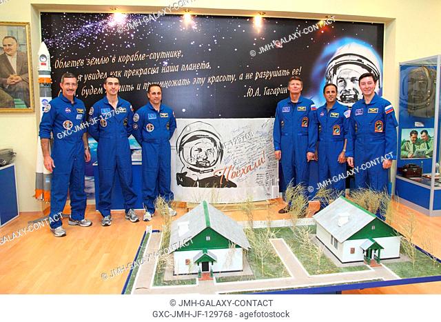 At the Baikonur Cosmodrome in Kazakhstan, the Expedition 30 prime and backup crews pose for pictures around a poster of Yuri Gagarin