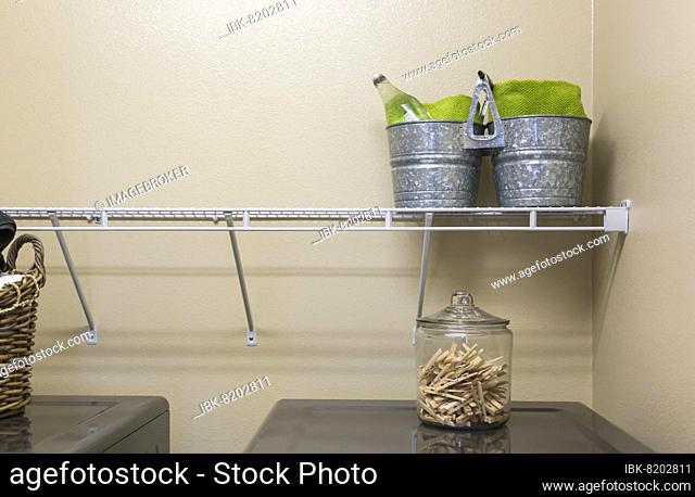 Abstract of laundry room with buckets and jar of clothespins