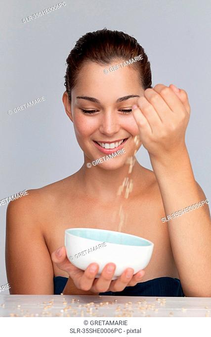 Smiling woman with bowl of grains