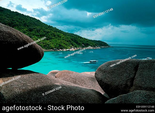 Top view from the mountain on tropical island, sea with boats and cloudy sky
