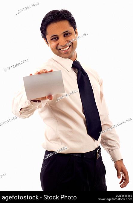 Happy Indian businessman presenting a blank card isolated over white background