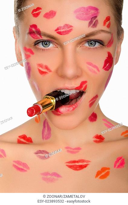 Beautiful woman with kisses on face and lipstick in mouth