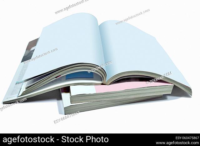 Opened blank pages of magazine or book, catalog on Stack of thick magazines isolated on a white background - a mock up for demonstrating your design