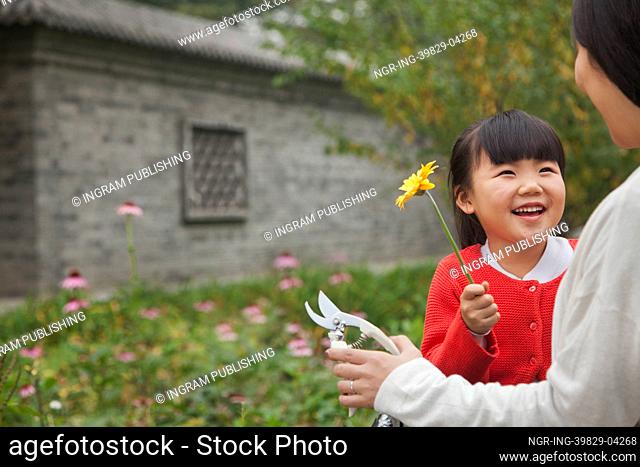 Smiling young girl with flower