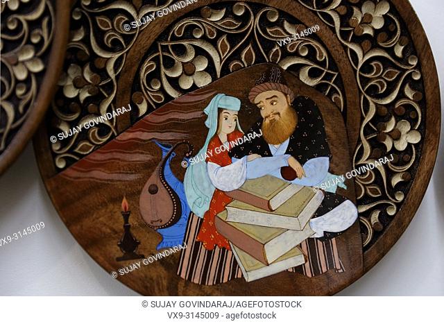 Tashkent, Uzbekistan - May 02, 2017: Hand carved and painted wooden plate in traditional Uzbek style, kept for display in the gallery at Abul Kasim Madrasa