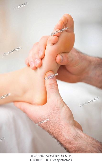 Foot receiving a massage by a physiotherapist