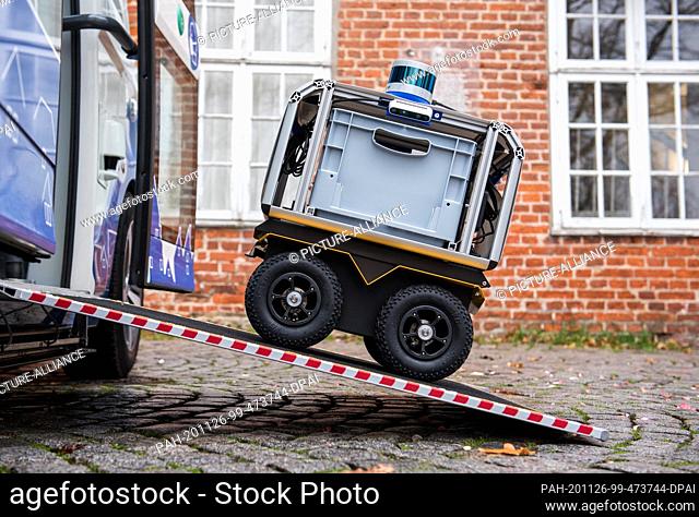 26 November 2020, Schleswig-Holstein, Lauenburg/Elbe: A prototype of a transport robot stands on the ramp of an autonomously driving bus during a press event