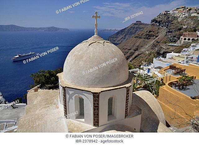 View from the crater rim across the rooftops of Firá or Thira into the Caldera, Ágios Ioánnis church at front, Santorini, Cyclades, Greek Islands, Greece