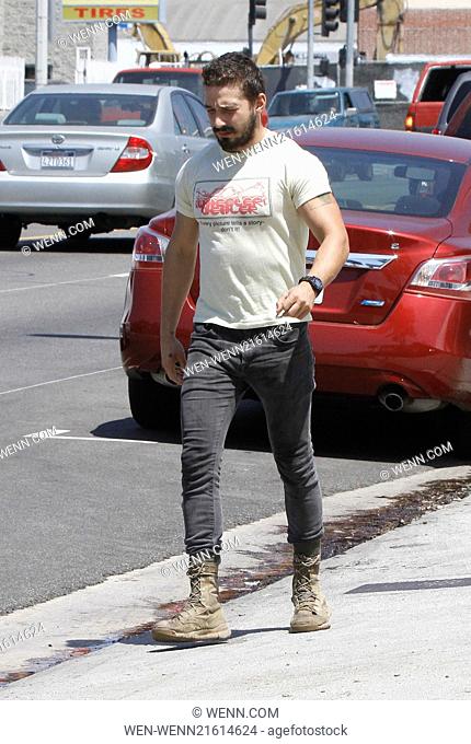 Shia LaBeouf returning to his vehicle caught wearing a t-shirt that says, 'Every picture tells a story - don't it!' Featuring: Shia LaBeouf Where: Los Angeles