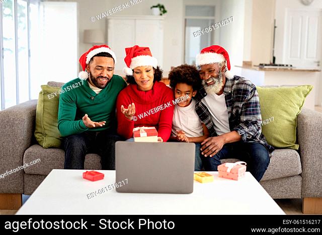 Multi-generation family having a video chat on laptop at home