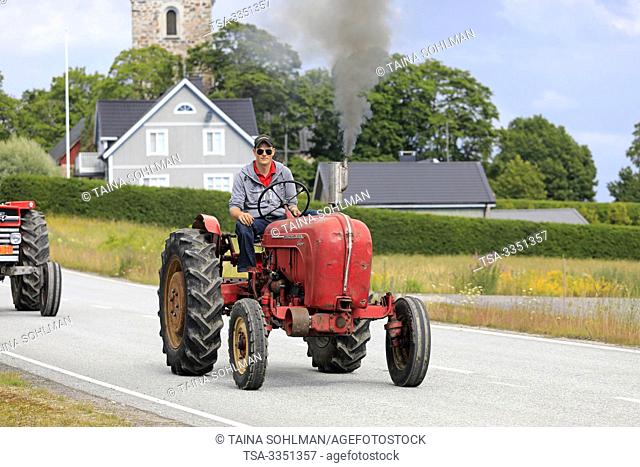 Kimito, Finland. July 6, 2019. Young man drives classic Porsche-Diesel Super Tractor on Kimito Traktorkavalkad, annual vintage tractor show and parade