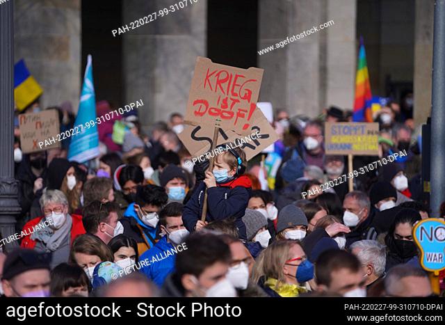 27 February 2022, Berlin: People hold signs, flags and placards during a demonstration under the slogan ""Stop the war! Peace for Ukraine and all Europe""...
