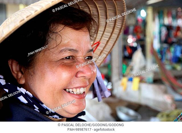 Vietnamese woman wearing a traditional Asian conical hat. Thay Ninh. Vietnam. | usage worldwide. - Tay Ninh/Tay Ninh/Vietnam