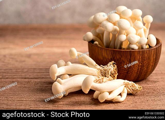 Shimeji, Fresh white bunapi mushrooms from Asia in wooden bowl