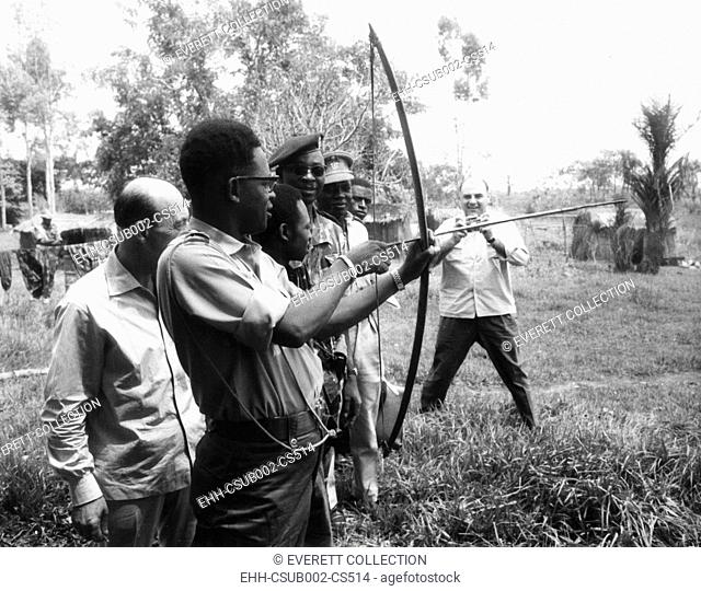 Gen. Joseph Mobutu, Chief of the Congolese Army, demonstrates his skill with bow and arrow. March 23, 1964. In 1960 Belgian forces aided his coup d’état that...