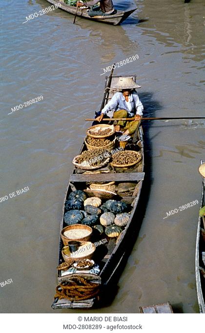 Pirogue full of fruits and greens sailing the river Chao Phraya. Bangkok, 1961