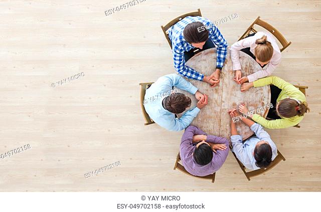 Startup diversity teamwork brainstorming meeting concept, people sitting around the table