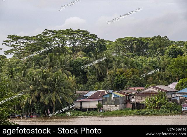 Malay houses by the Sarawak river, Kuching, East Malaysia, Borneo. Malay houses by the Sarawak River in Kuching are traditional wooden stilt houses built and...
