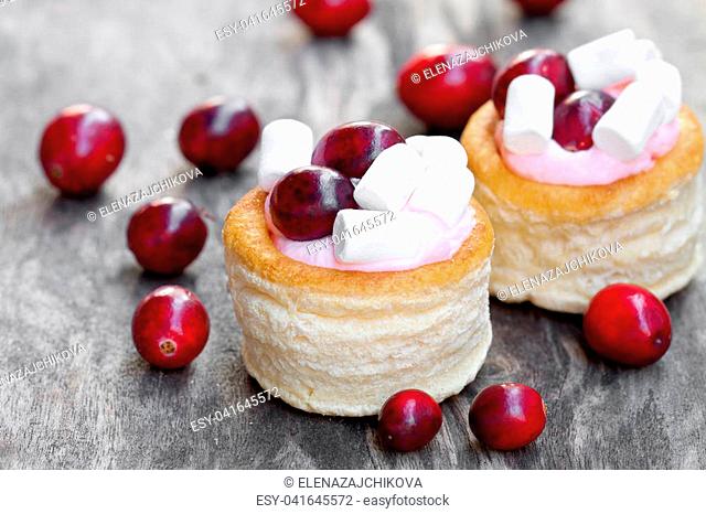 puff pastry stuffed with fruity soft cream cheese and cranberry on wooden background