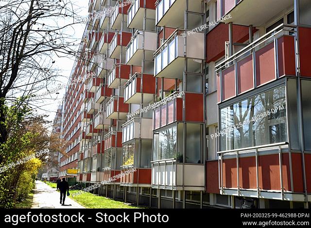 24 March 2020, Saxony, Leipzig: Few people walk along one of the longest apartment blocks in Germany, the ""Lange Lene"" in the southeast of Leipzig
