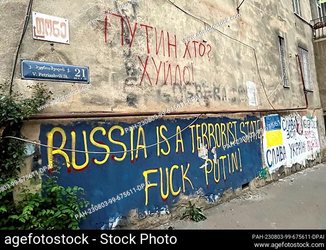 01 May 2023, Georgia, Tiflis: On the wall of a house in one of the capital's neighborhoods, anti-Russian slogans are written in English and Ukrainian