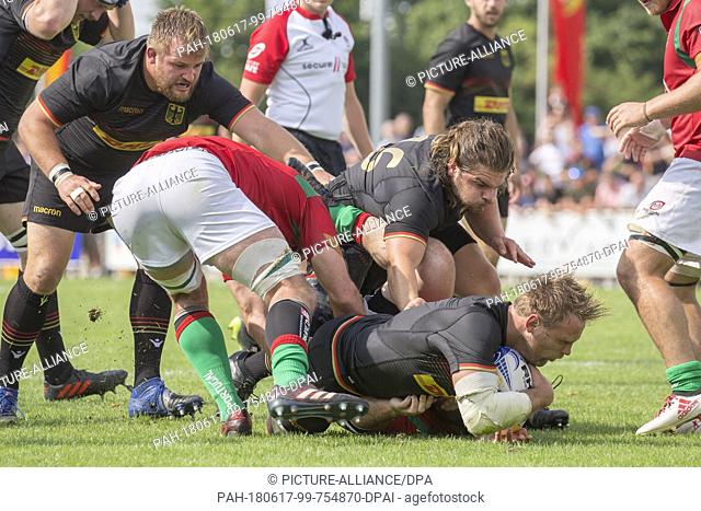 16 June 2018, Germany, Heidelberg: Qualification match for the 2019 Rugby World Cup in Japan, Germany vs Portugal: Jaco Otto and Cyrille Andreu (Portugal